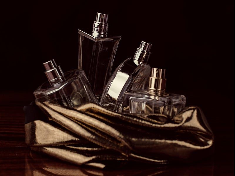 Applying a long lasting smell perfume to pulse points.